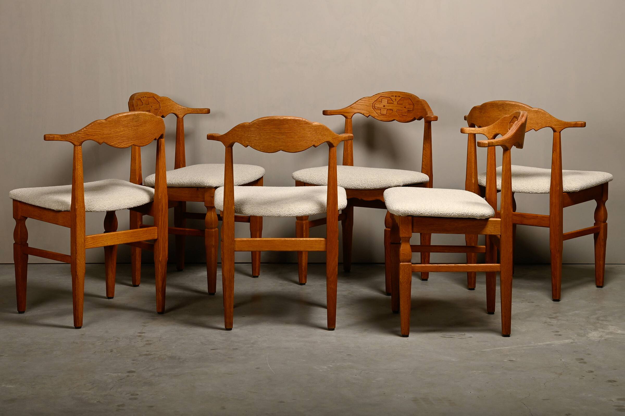 Henning Kjærnulf dining chairs set in Oak and Off White Bouclé, Denmark, 1960s