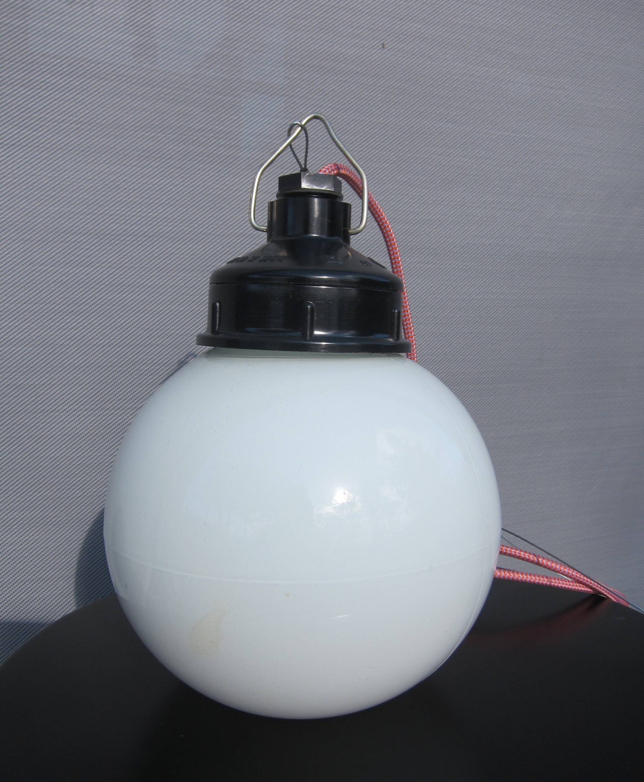 Trio of opal glass and bakelite globe pendant lights