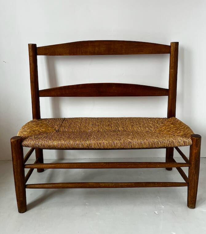 Old wooden and straw bench
