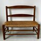 Old wooden and straw bench