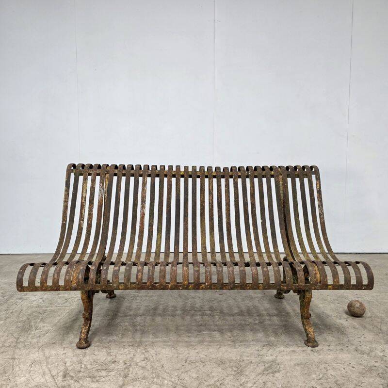 Cast iron garden bench from the late 19th century with slatted backrest.