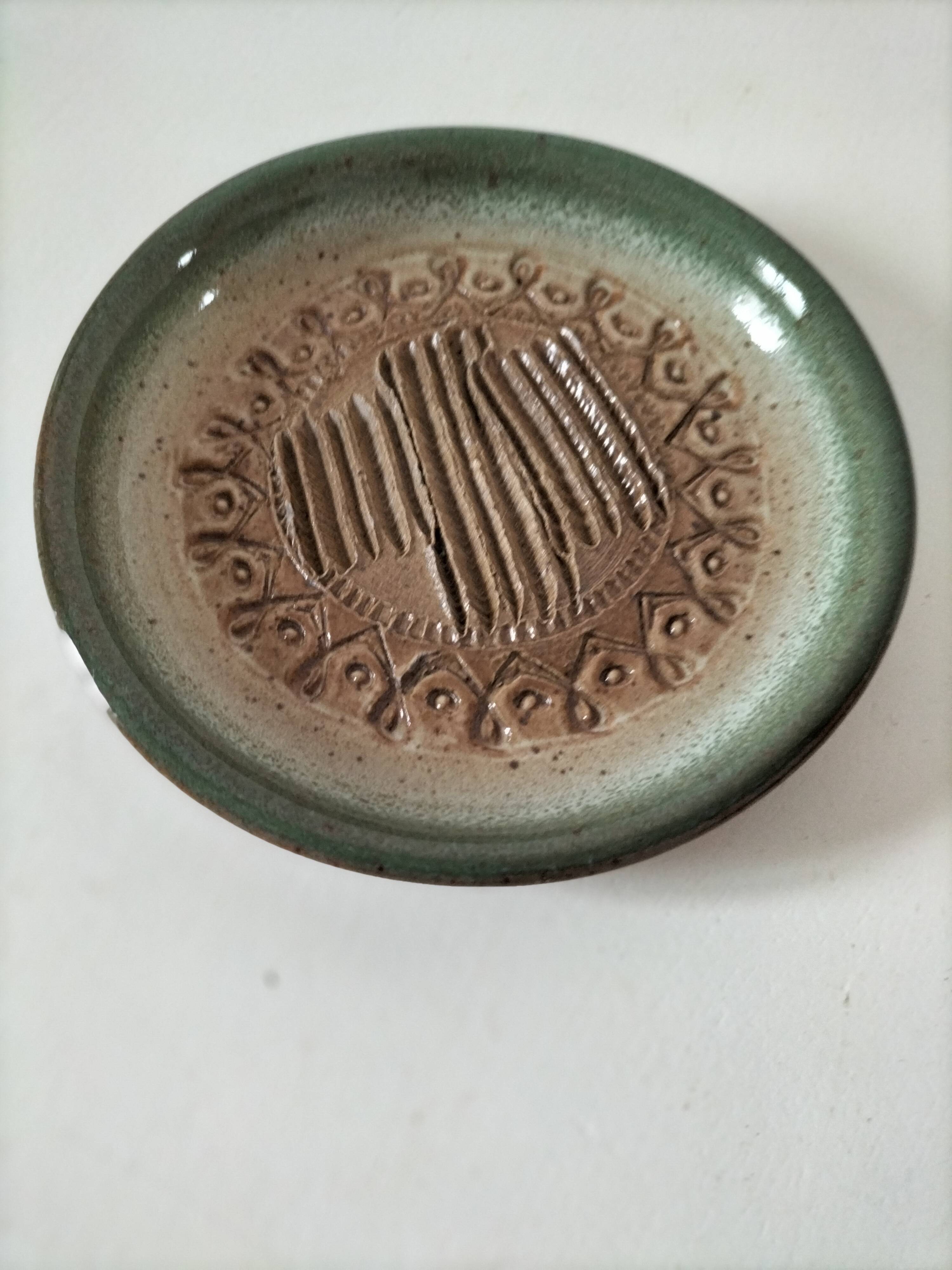 Signed stoneware bowl from Puisaye, relief decoration.