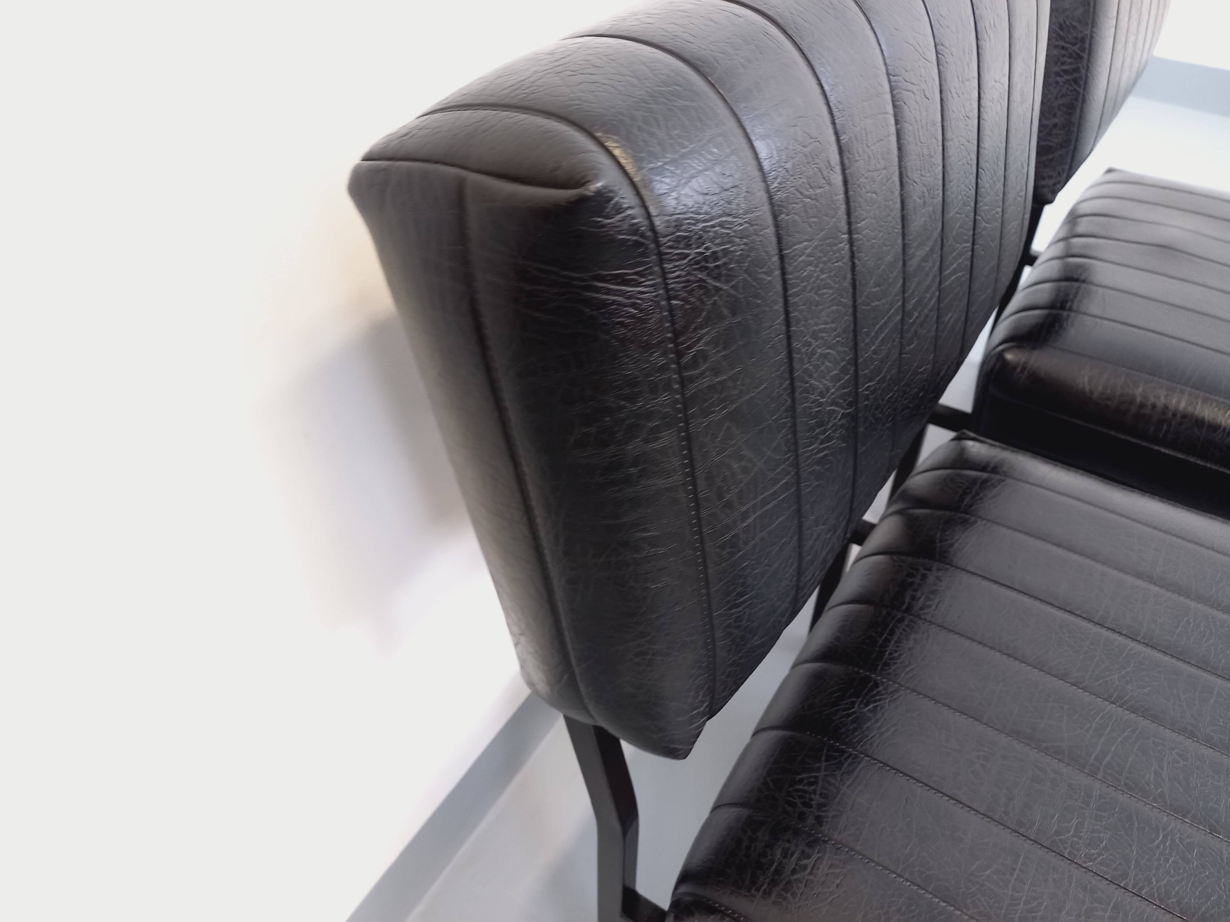 Set of 2 vintage modernist armchairs in black faux leather and metal.