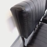 Set of 2 vintage modernist armchairs in black faux leather and metal.