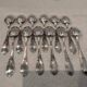 12 silver-plated dessert spoons with rocaille ribbon decoration, 18.5 cm
