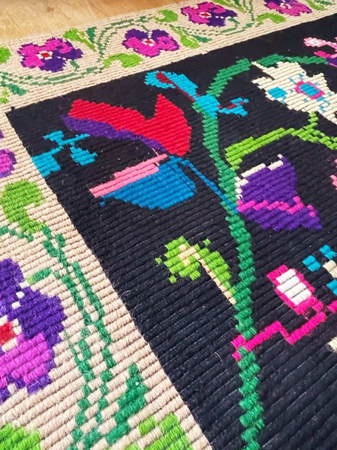 Romanian wool carpet floral design with green border on black background 180x153cm