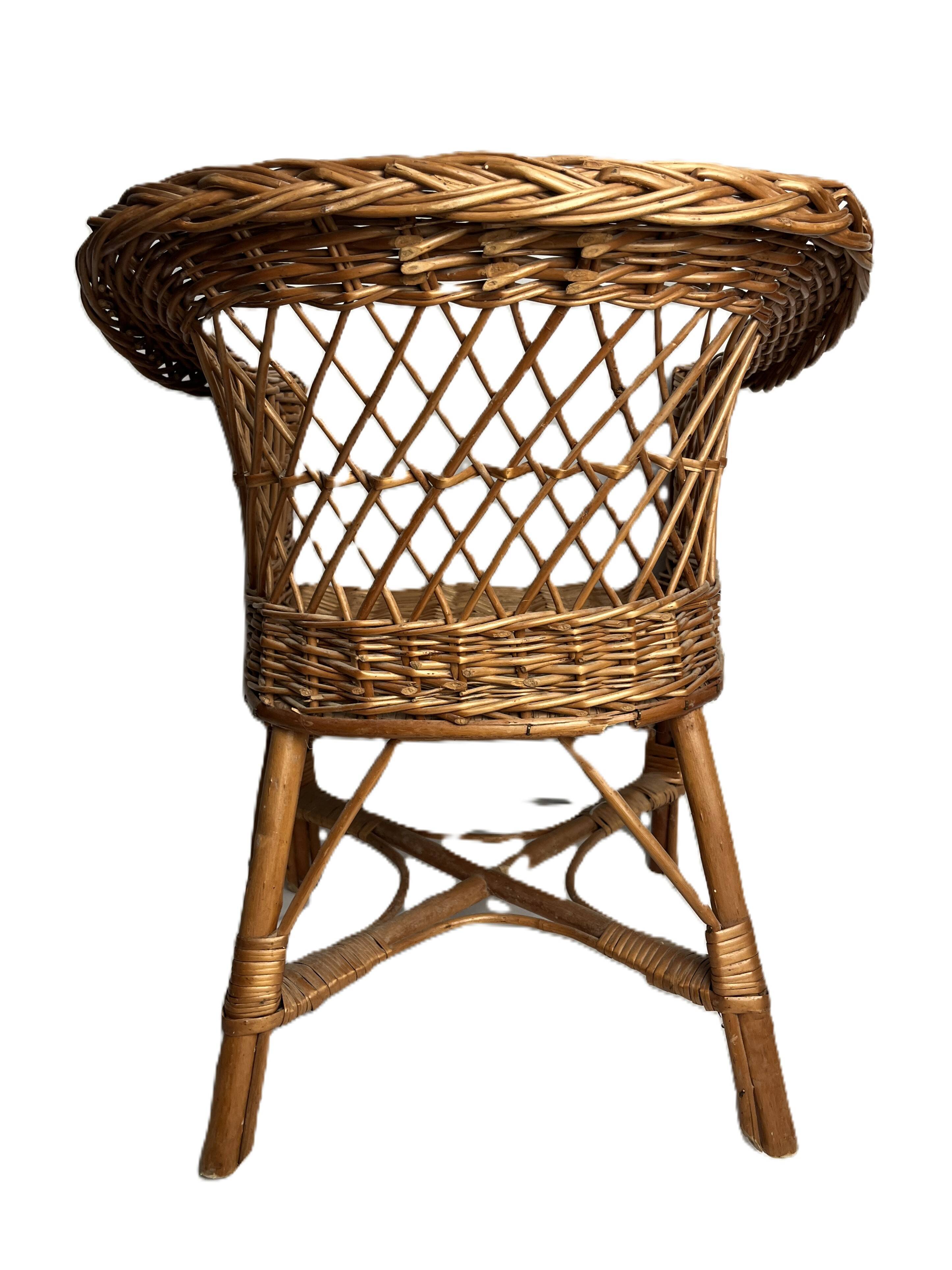 Vintage, children's armchair in woven rattan from around 1970.