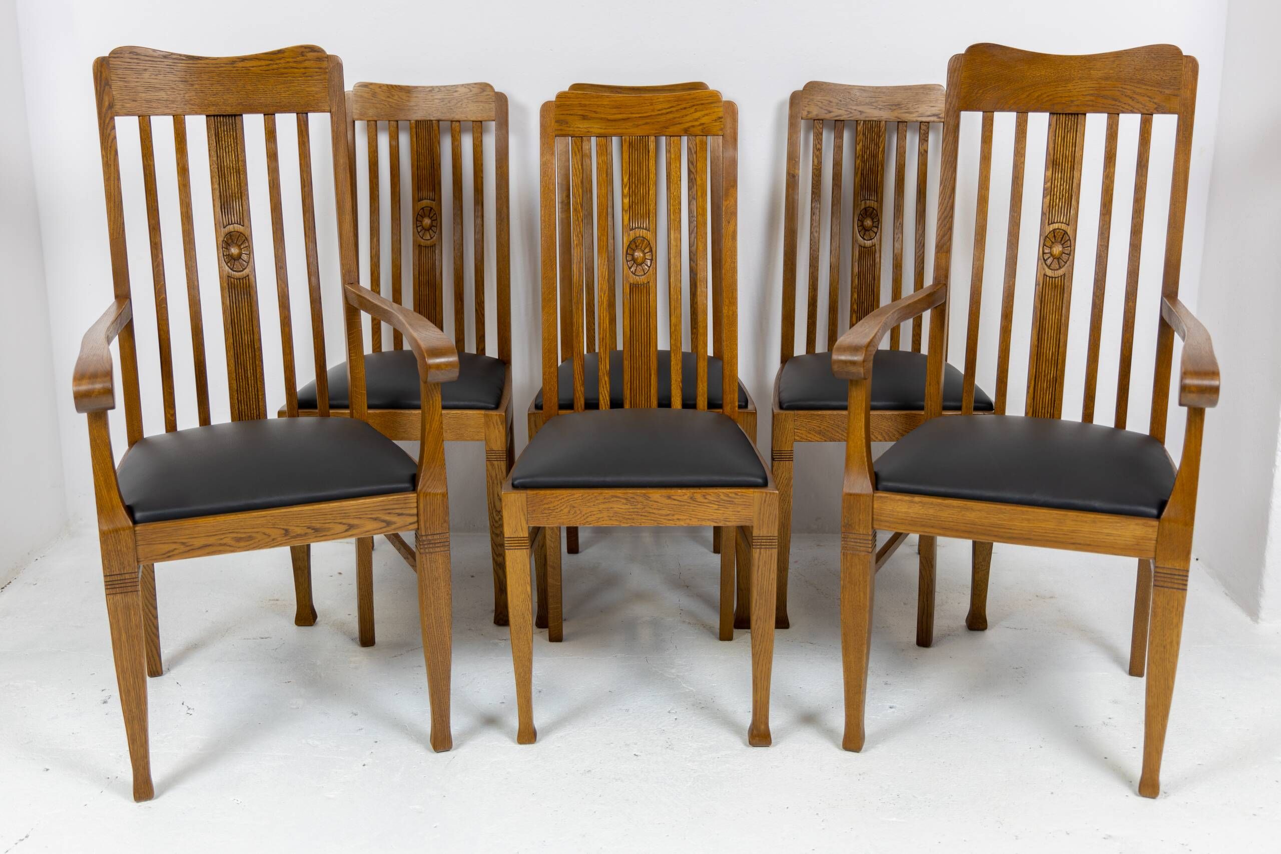 Set of 6 Art Nouveau chairs and armchairs in oak and leather.