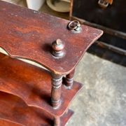 Curved and turned wooden wall shelf