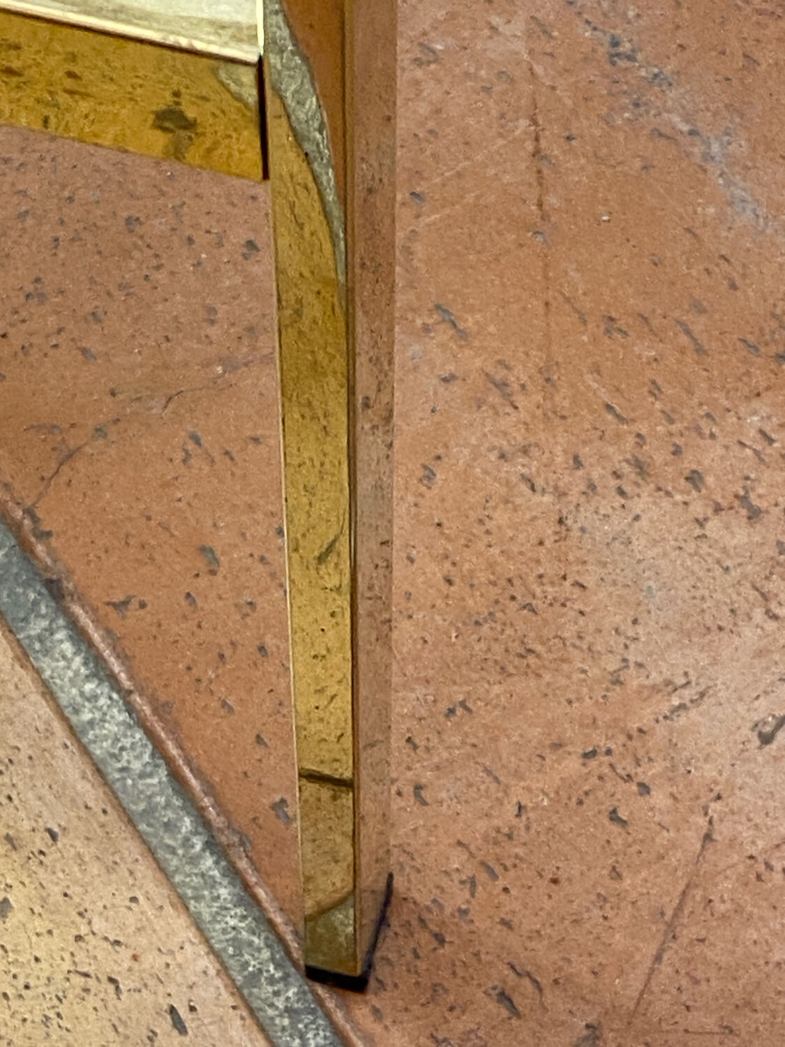 Gold metal and smoked glass console table.