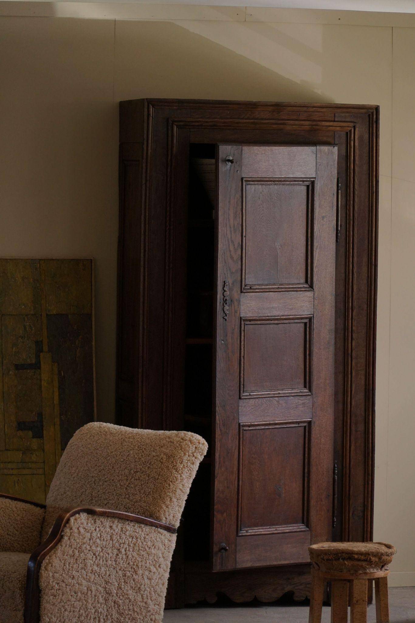 Tall antique oak wardrobe, made by a French cabinetmaker, late 19th century.