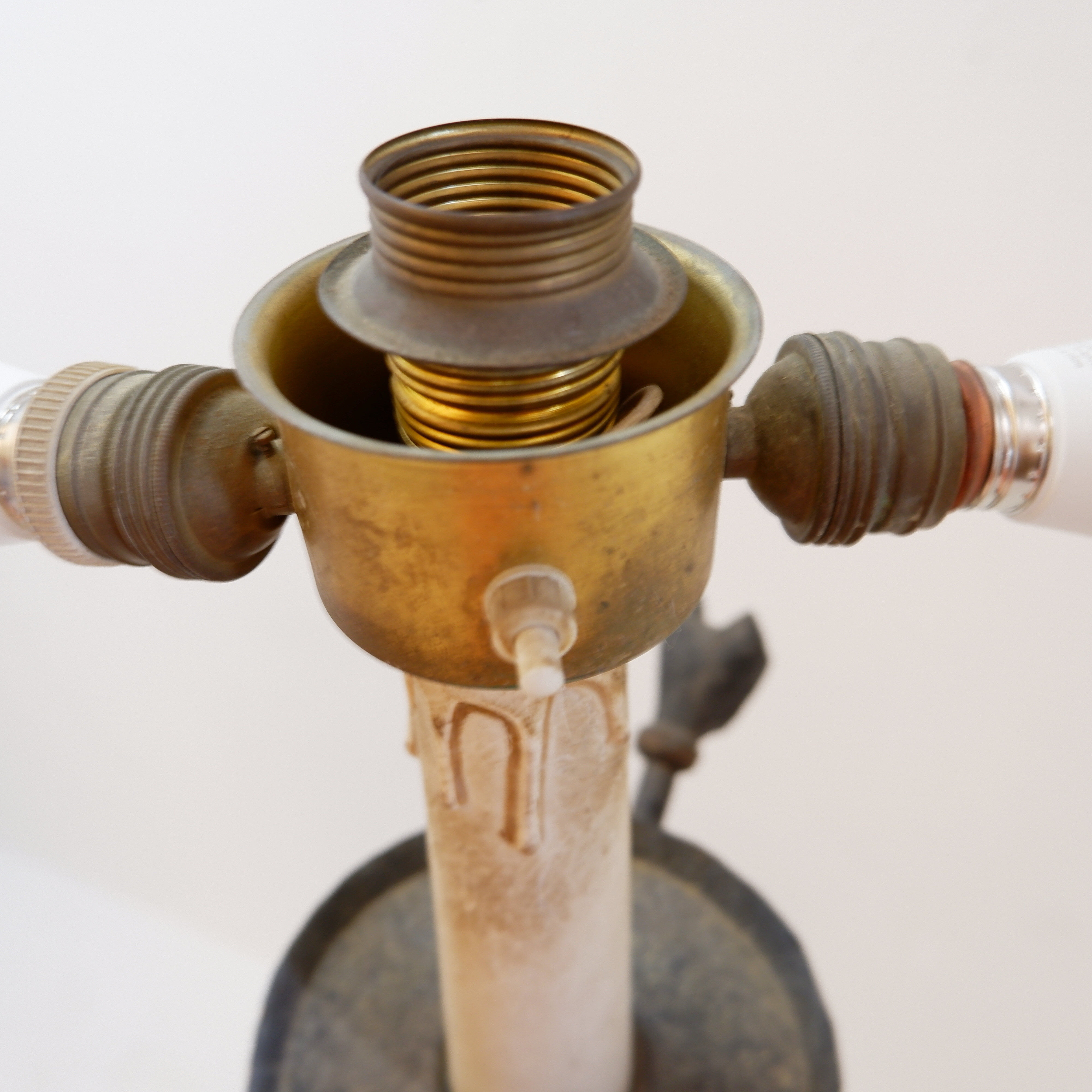 Wrought iron tripod floor lamp decorated with stylized animal heads