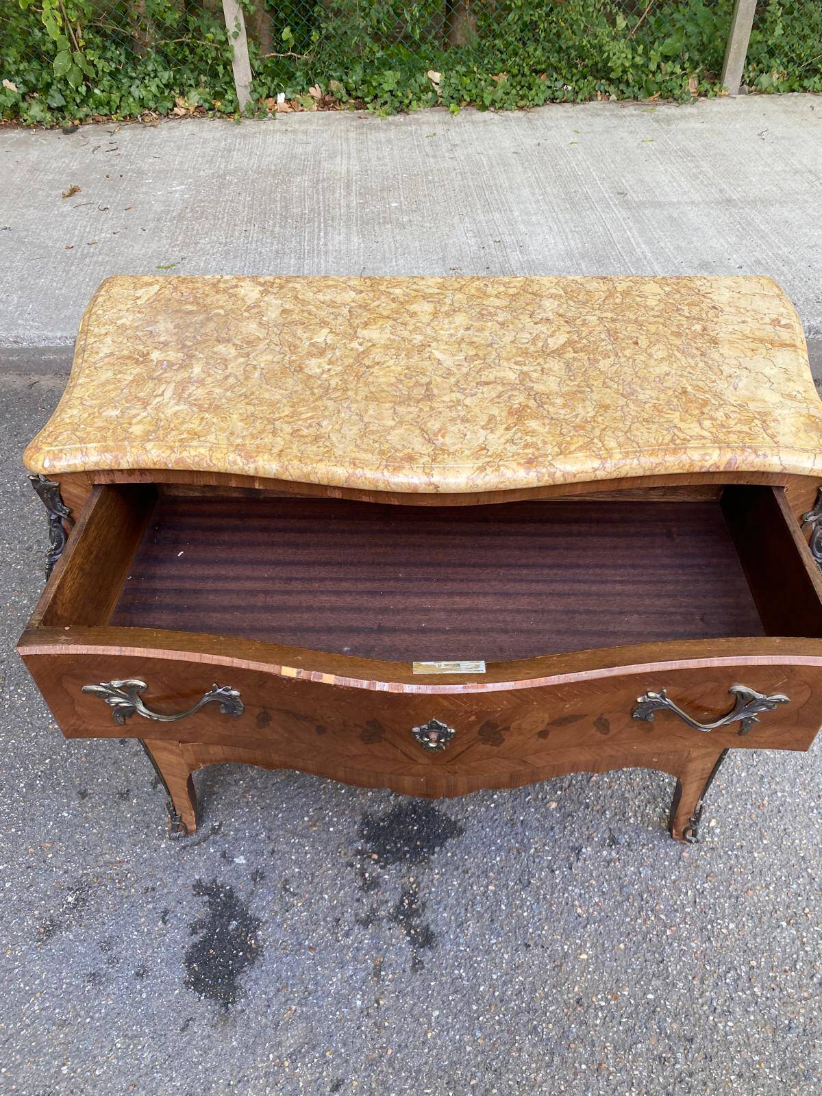 Curved Louis XV chest of drawers in marquetry and beige marble