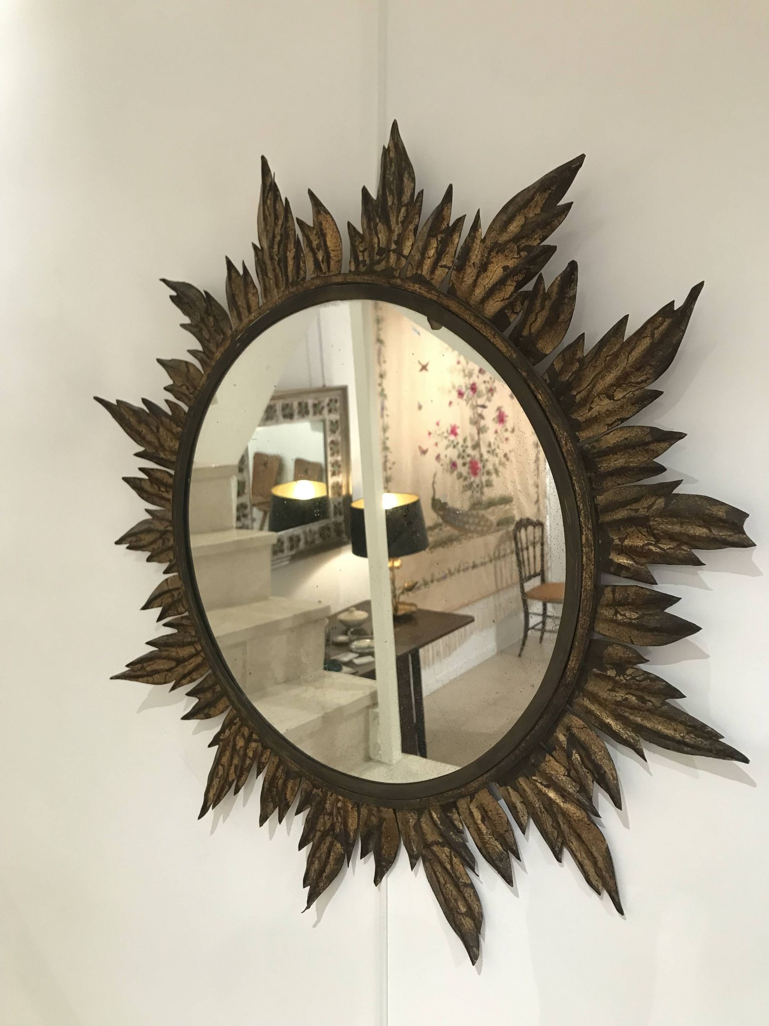 Sun mirror decorated with golden leaves, circa 1950.