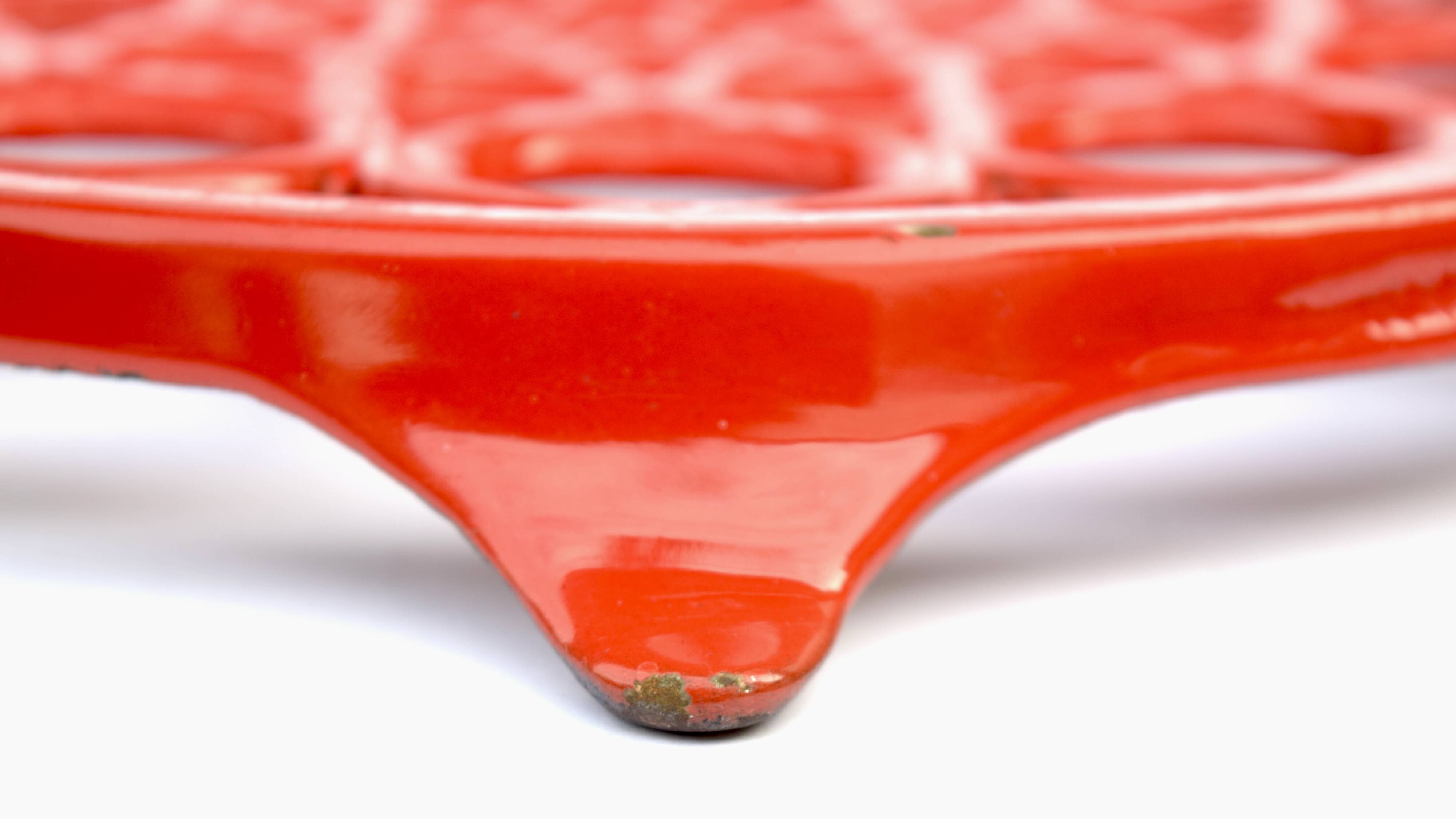 Vintage red enameled cast iron trivet