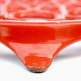 Vintage red enameled cast iron trivet