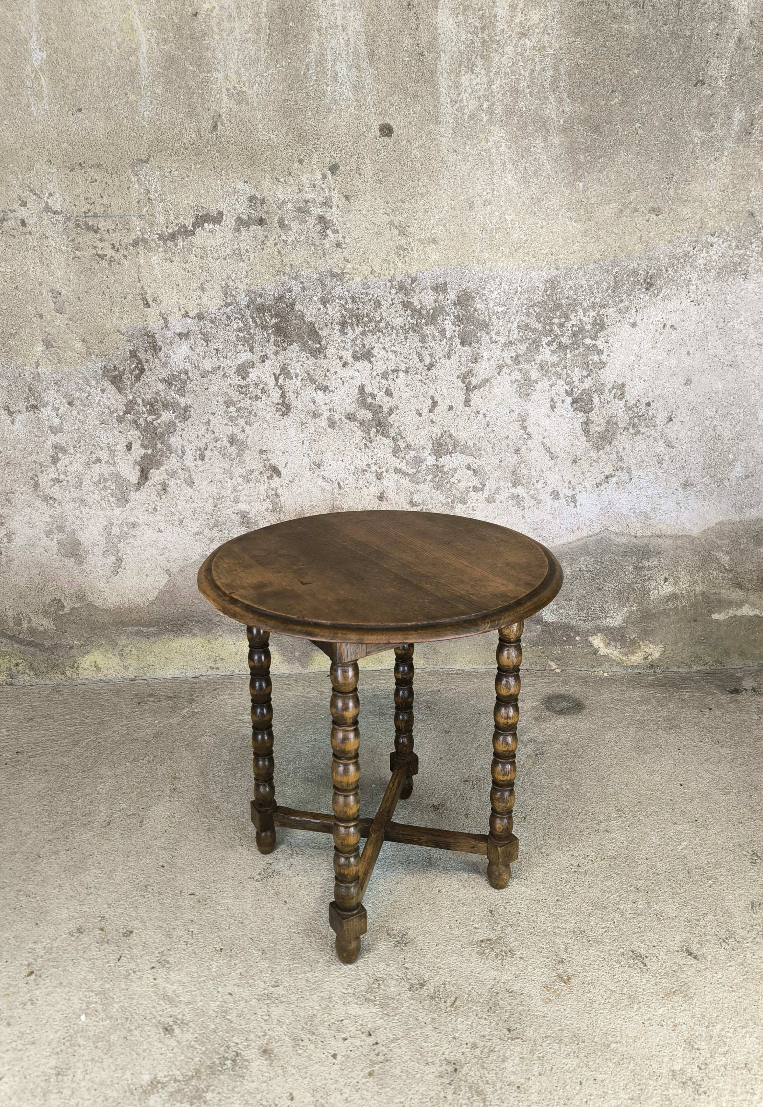 Vintage gueridon with beaded wooden legs.