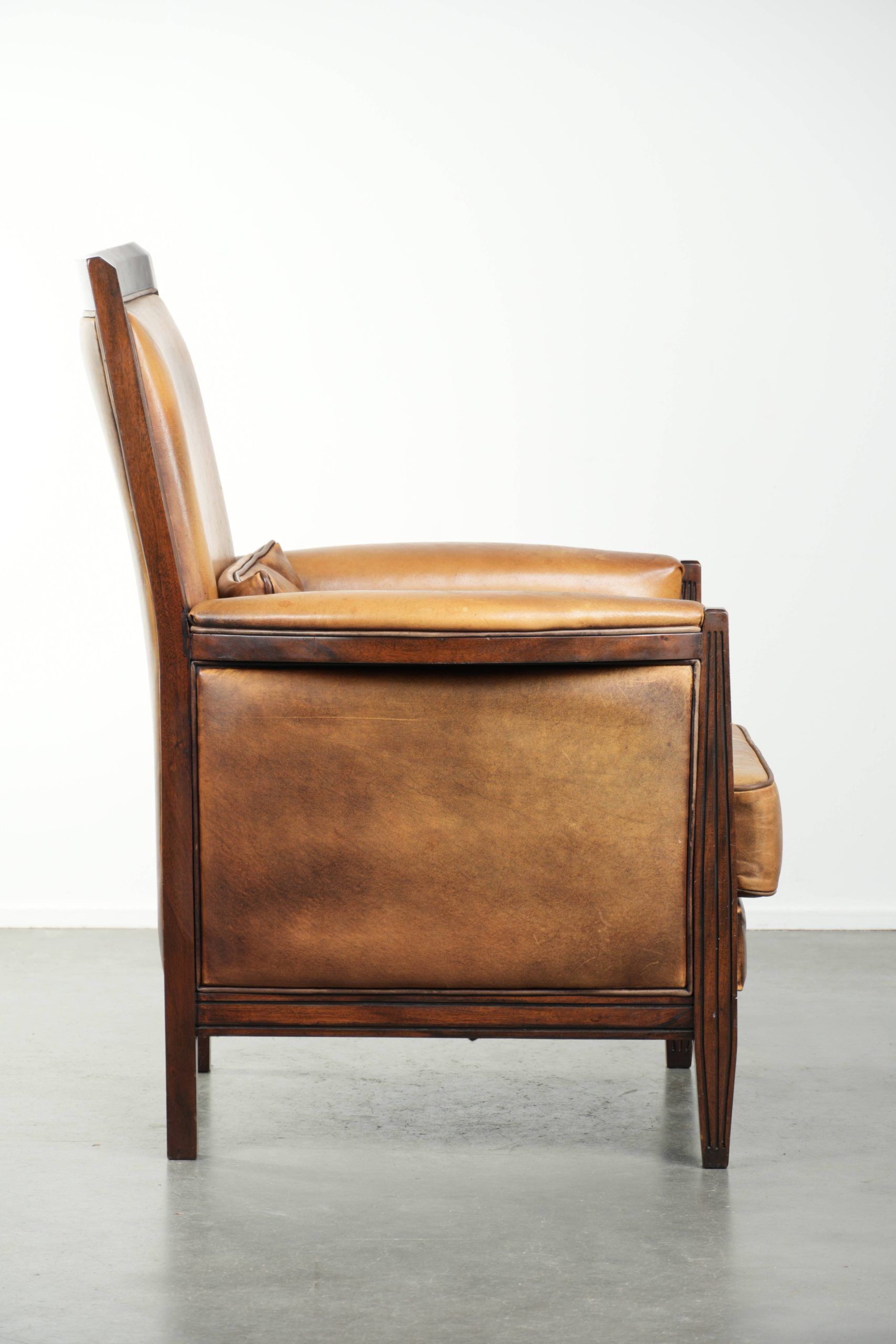 Cognac-coloured Art Deco design armchair made of sheepskin with a high back