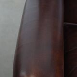Comfortable wingback chair in English style made of cowhide leather