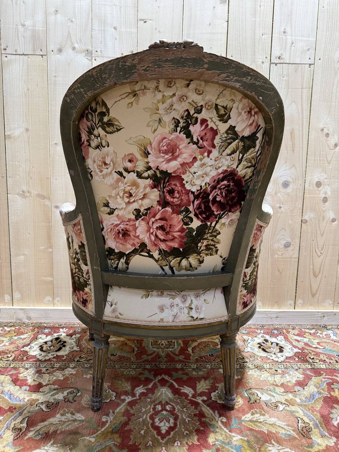 Reupholstered bergère with floral fabric in Louis XVI style.