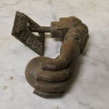 Antique cast iron door knocker in the shape of a 19th century hand