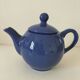 Vintage deep blue teapot, minimalist round shape.