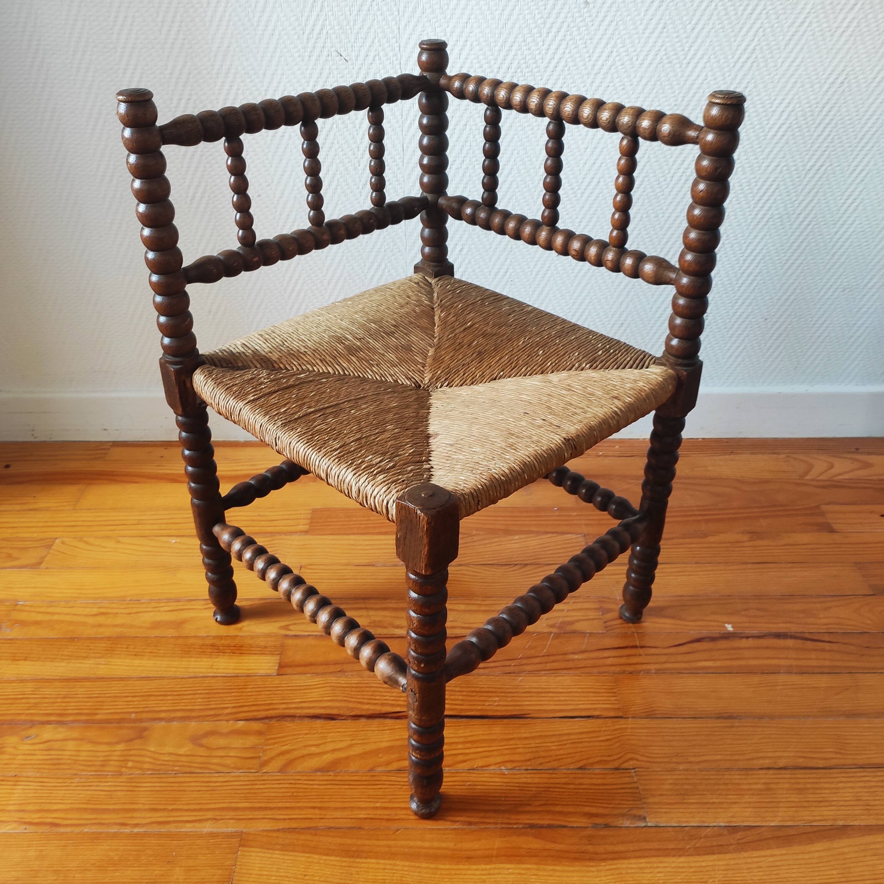 Antique corner chair made of turned wood spindle.