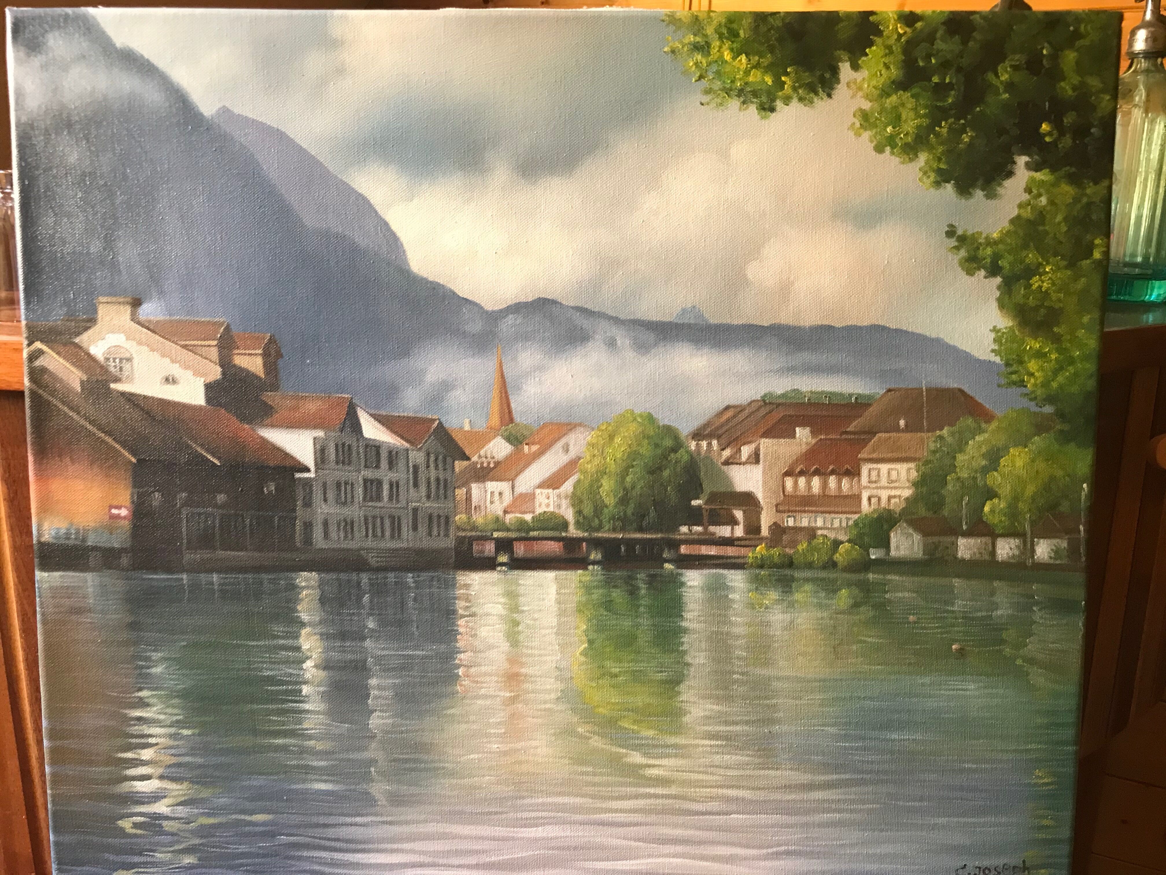 Painting on canvas of a village at the water's edge