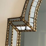 Mirror consisting of multi-faceted mirrors and brass garlands, French work, around 1970