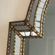 Mirror consisting of multi-faceted mirrors and brass garlands, French work, around 1970
