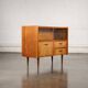 Old TV cabinet with brass handles.