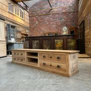 An old piece of workshop furniture transformed into a TV stand