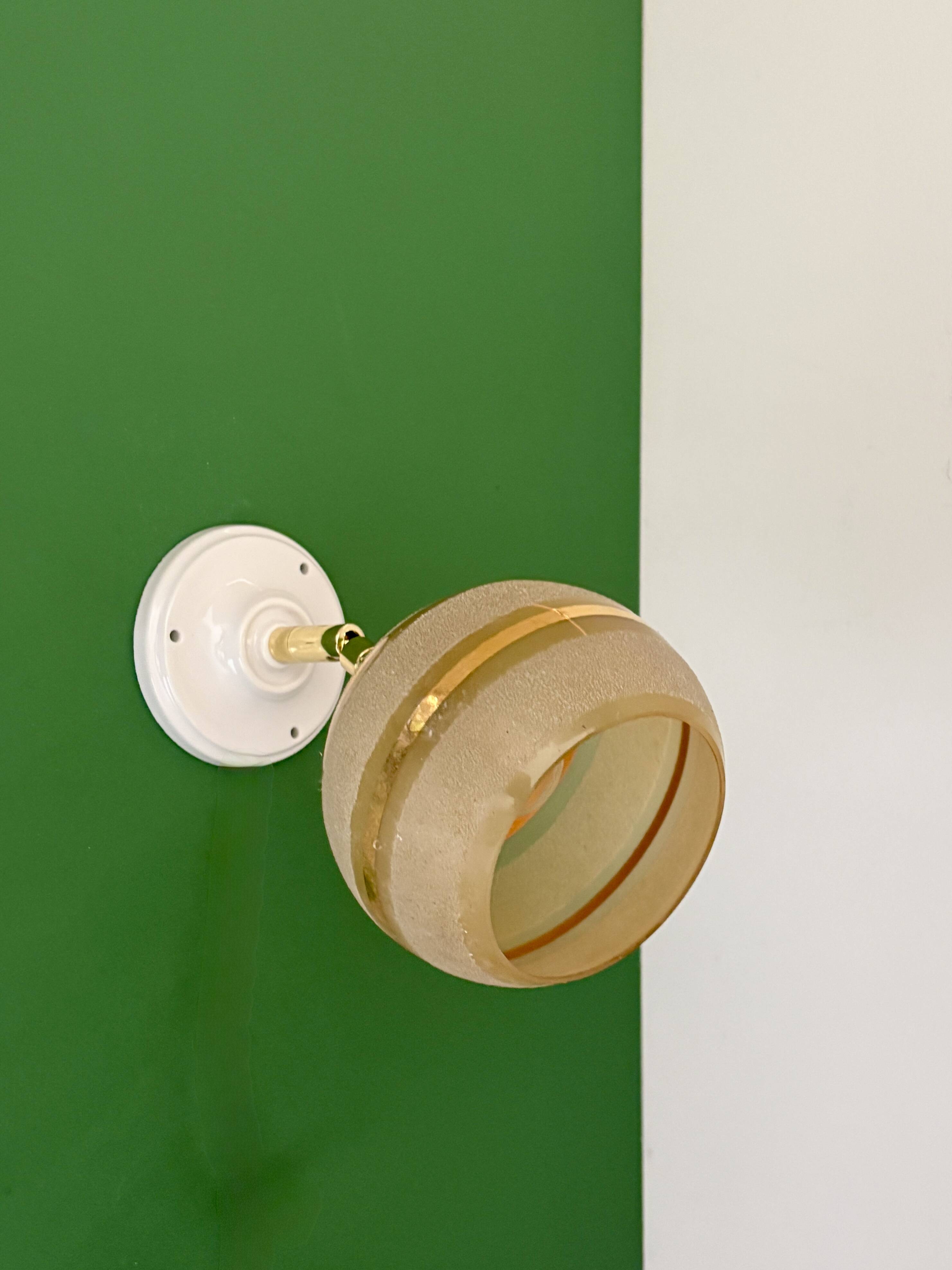 Vintage globe wall light in frosted yellow and gold glass.