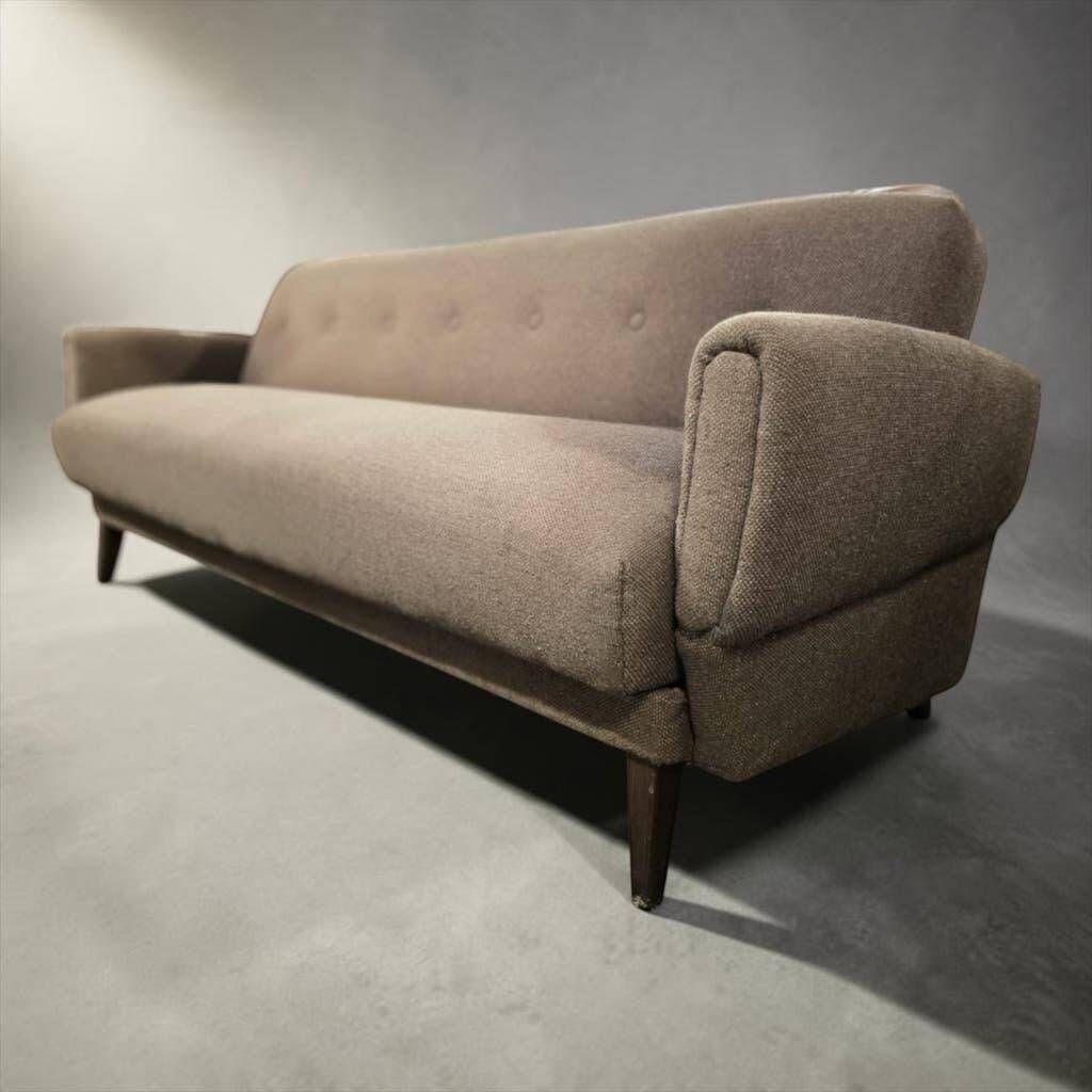 Vintage armchair/sofa/lounge in taupe colour with a stain.