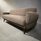 Vintage armchair/sofa/lounge in taupe colour with a stain.
