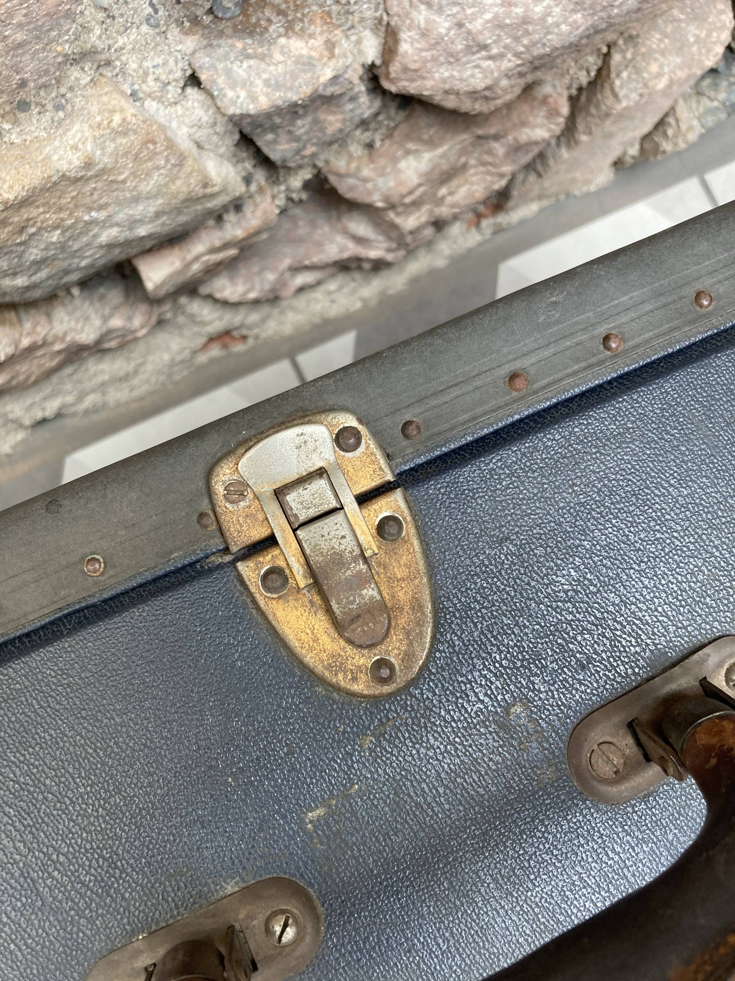 Midnight blue suitcase of representative 30s