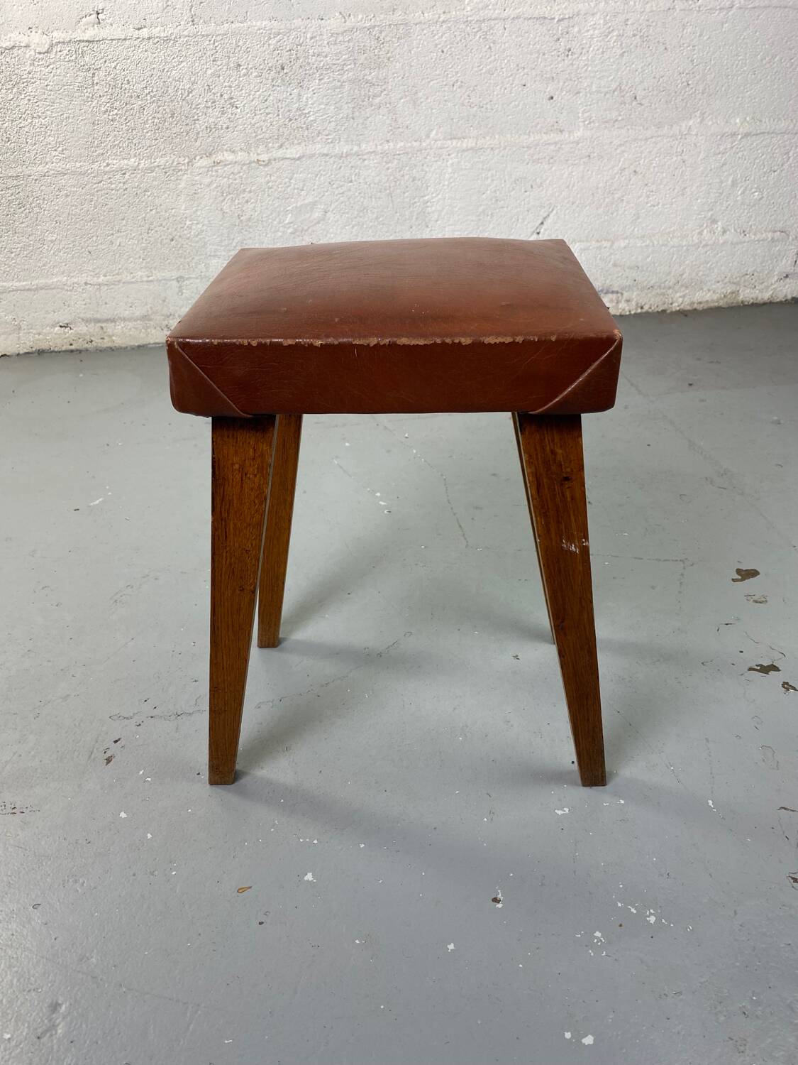 Small stool or footrest in wood and leather