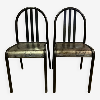 Two vintage chairs with bars.