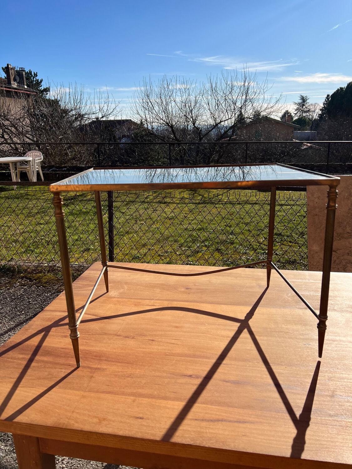 Brass side table with smoked glass.