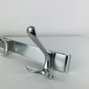 Wall-mounted coat rack, strip of 3 aluminium hooks from the 1960s.