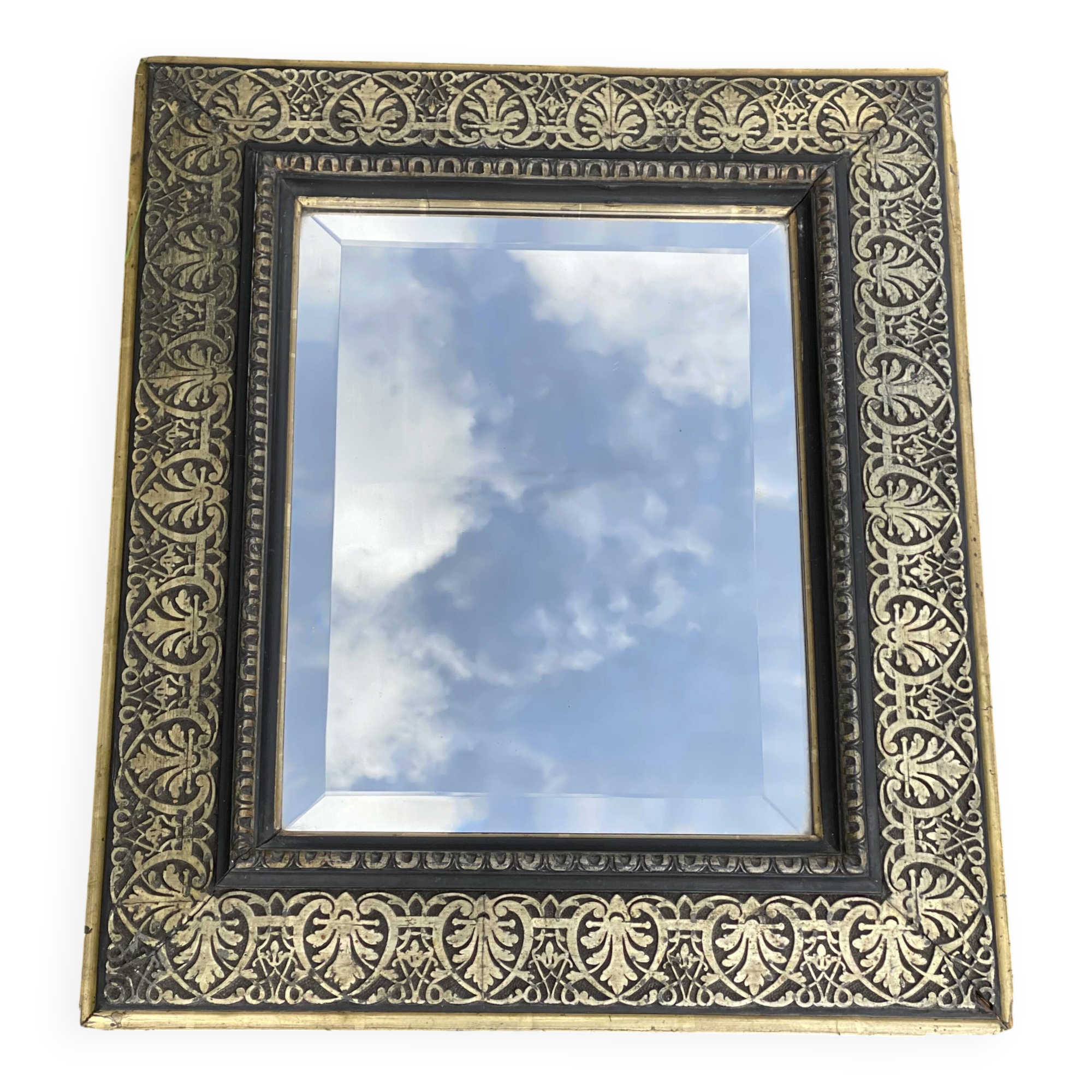 Bevelled mirror from the 19th century with gold and black palmettes.