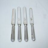 Set of four silver metal knives