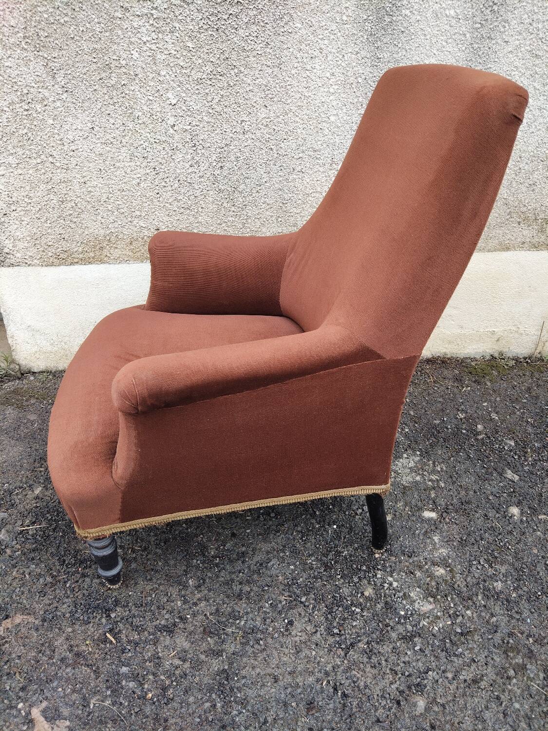 Antique brown velvet tub chair – turned legs and brass rings.