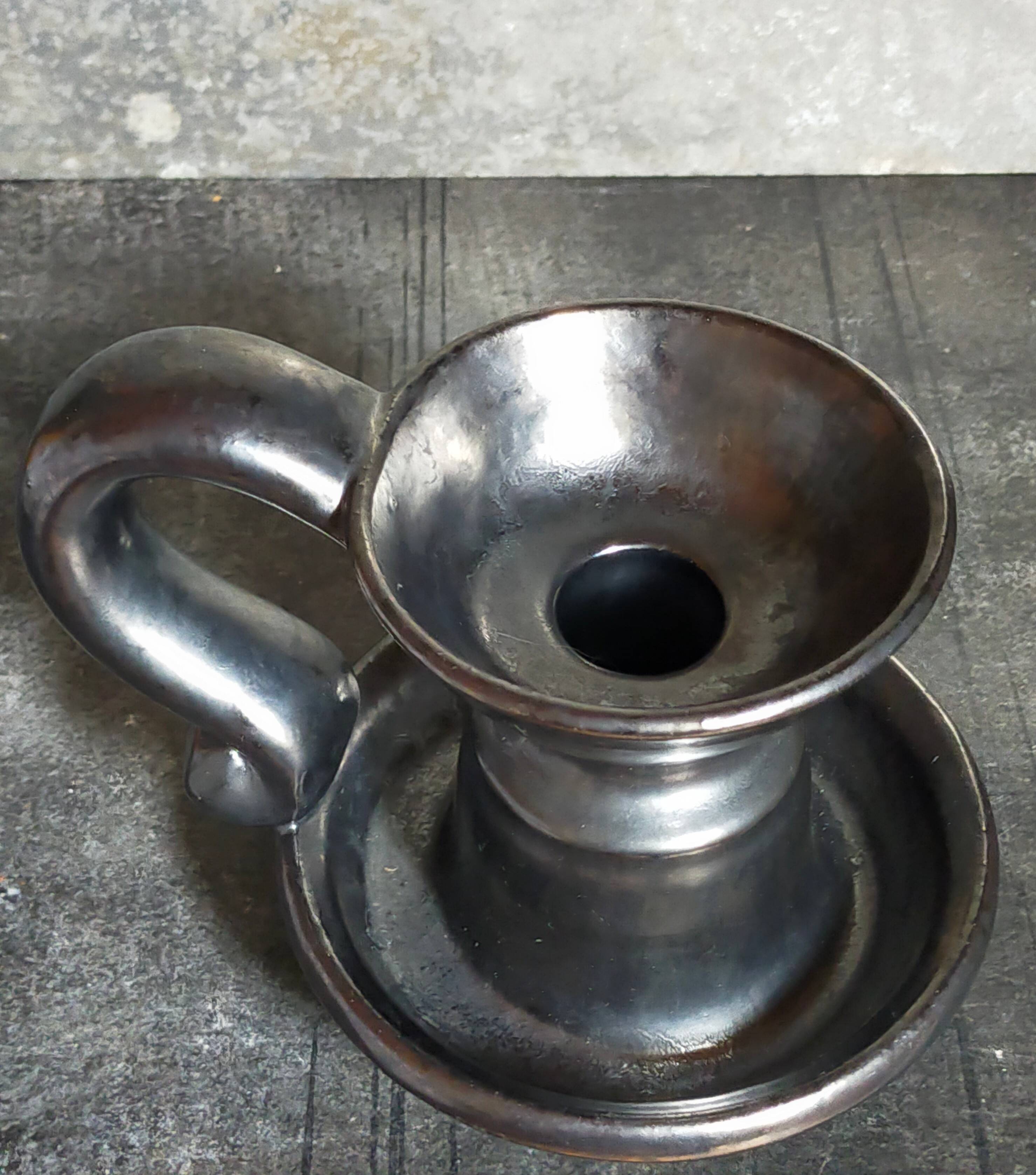 1950s iridescent black ceramic hand candle holder