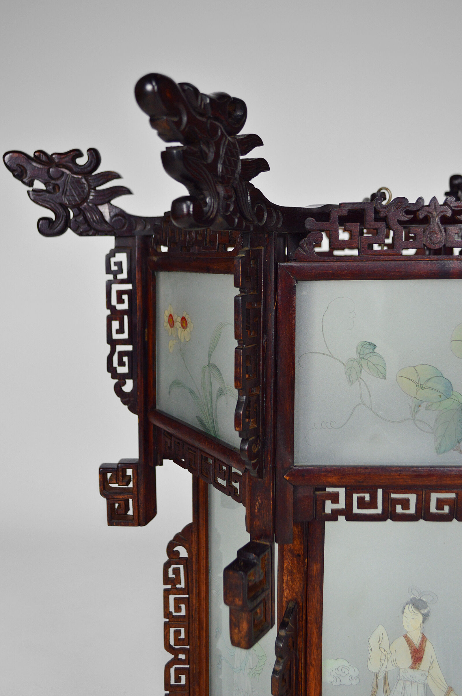 Asian wooden lantern carved with dragons and painted glass panels