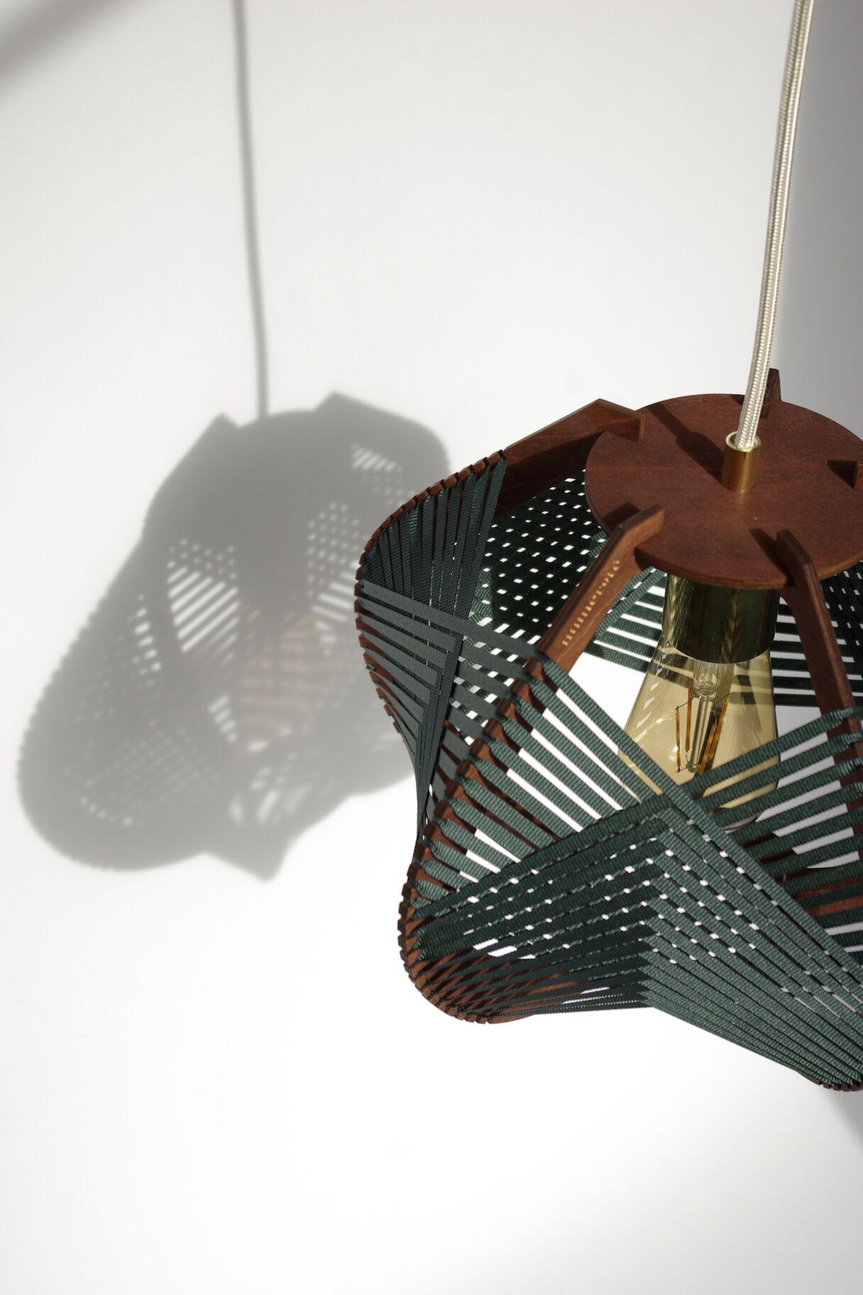 Dark green woven lamp to hang