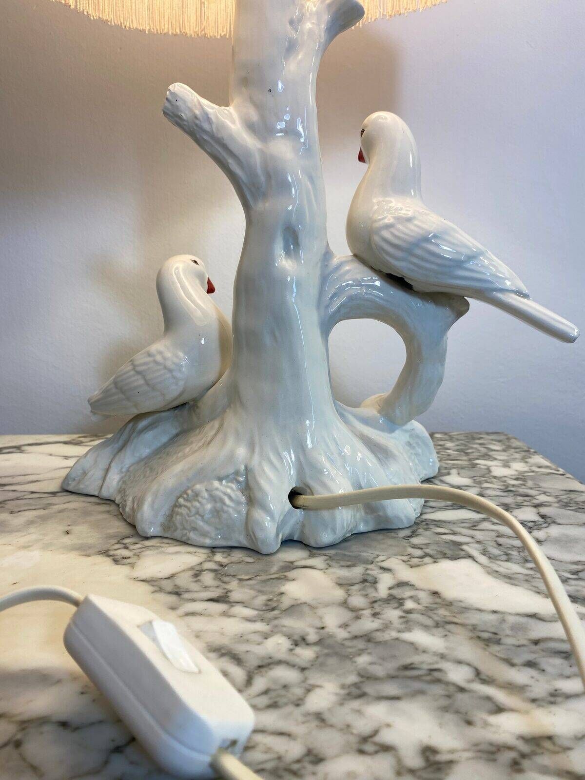 Ceramic lamp with birds, pink fringed shade, 1950s.