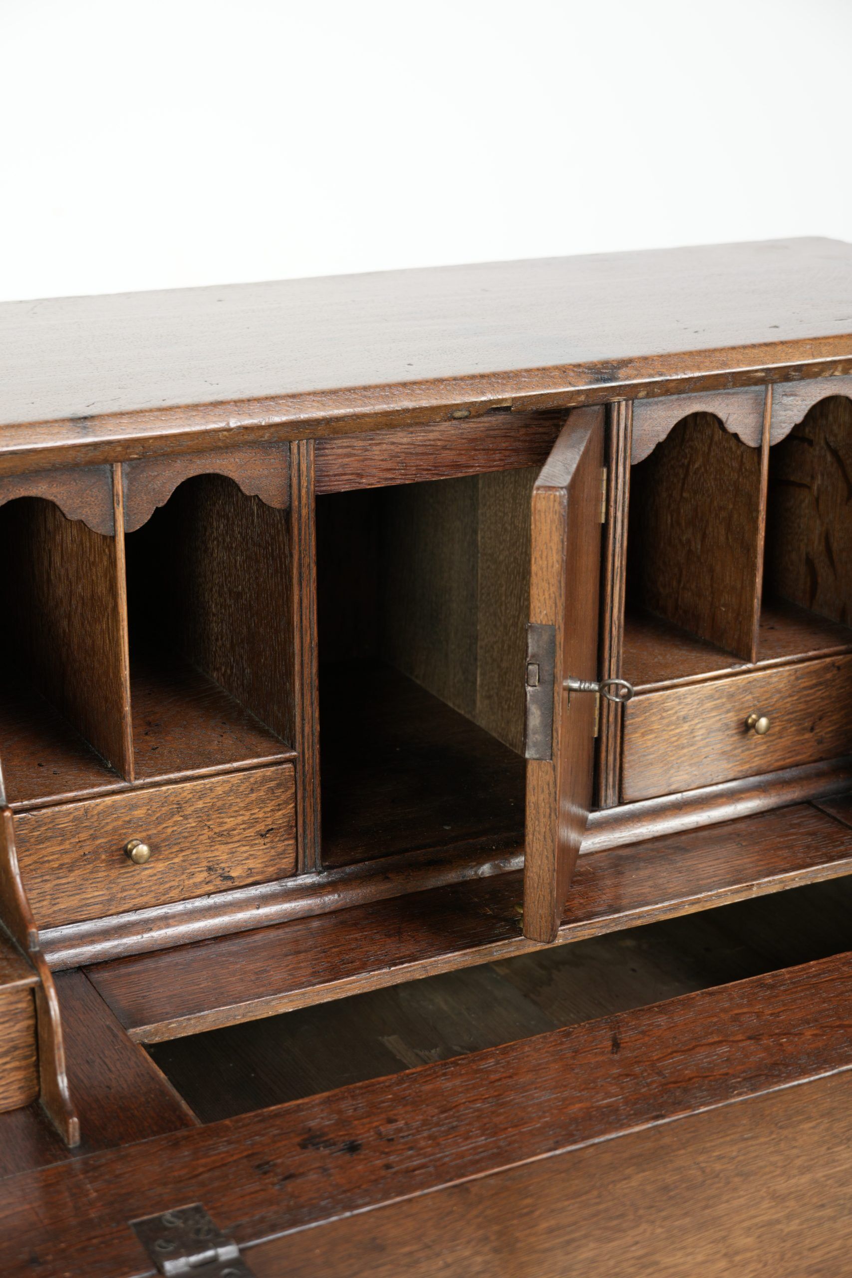 Antique English oak secretary from the 18th century with a stepped interior