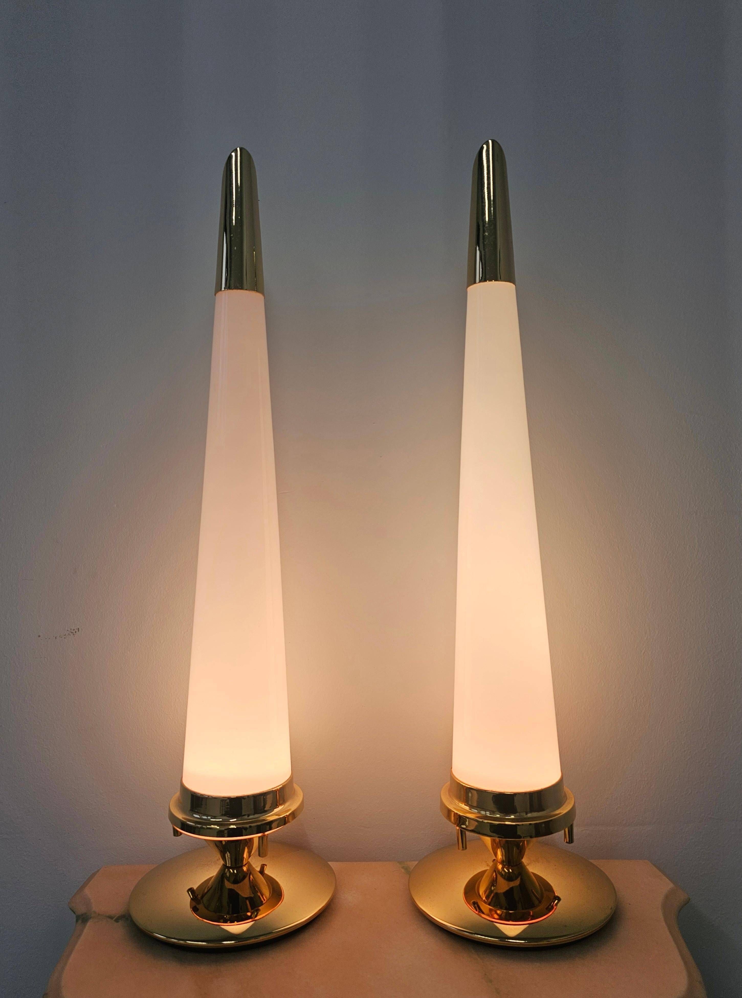 Pair of Hollywood Regency table lamps in brass with glass shades.