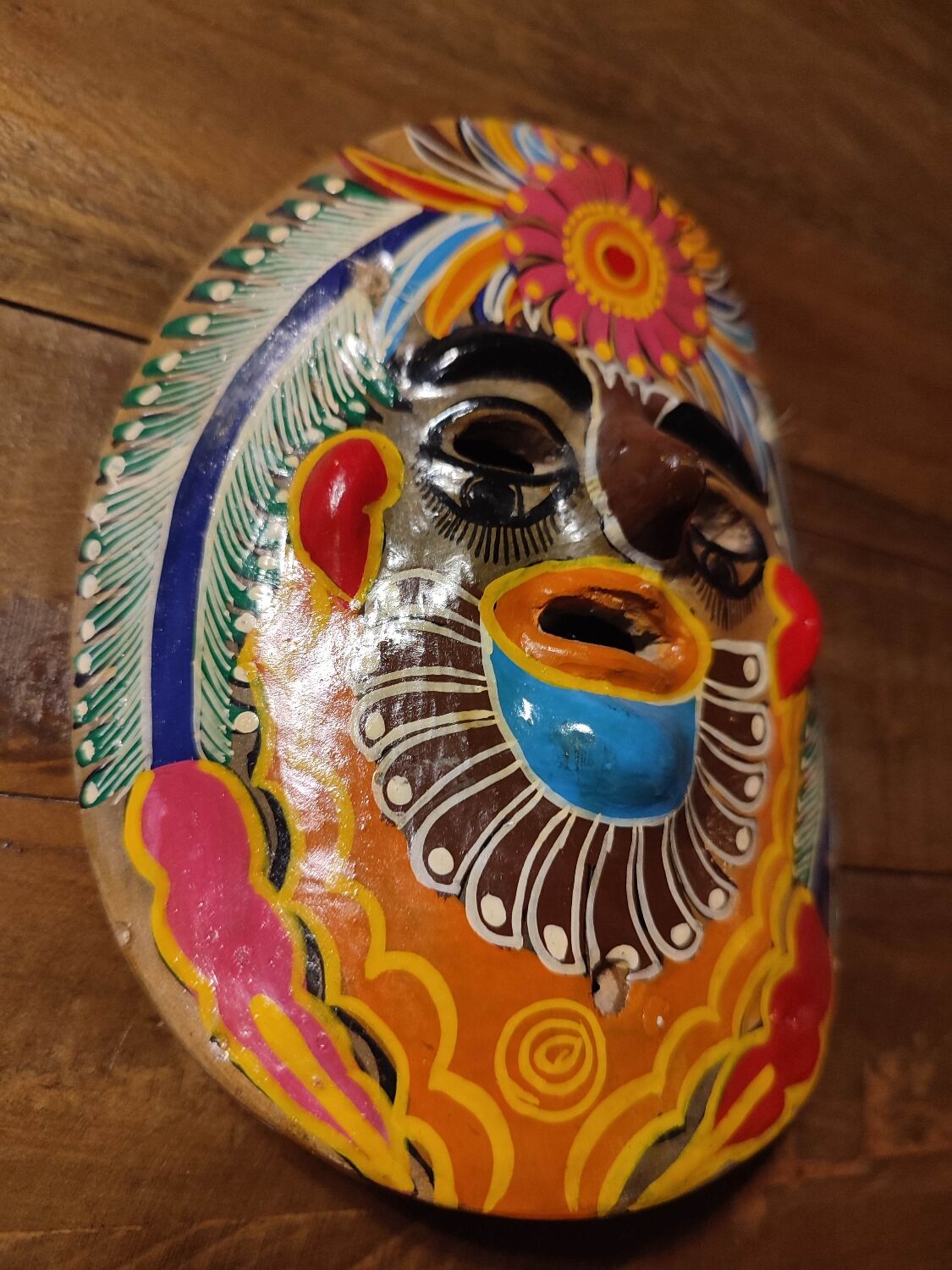 Mexican mask from the 1970s, hand-painted on terracotta.